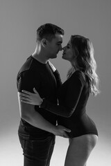 Happy pregnant couple looking to the future on white background