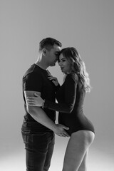 Happy pregnant couple looking to the future on white background