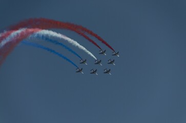 Aerobatics demonstration of the French Acrobatic Patrol in the air against the blue sky