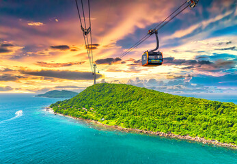 View of longest cable car ride in the world, Phu Quoc island, Vietnam, sunset sky. Below is seascape with tropical islands and boats. - obrazy, fototapety, plakaty