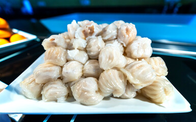 Steamed dumpling filled with meat on buffet plate. Cake with fish sauce is a favorite dish of the Chinese in Vietnam