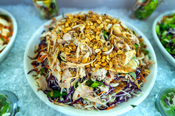 Salad of meat, jellyfish mixed with vegetables garnished with fried peanuts and onions on a plate for restaurant buffet © huythoai