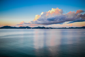 Early sunrise In August, Japan, Okinawa, Nago Clouds are reflected in the surface of the sea