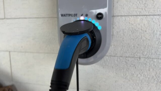 wallbox with plugged charging cable charging electric car