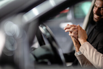 couple in car prepairing to go on trip holding hands