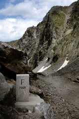 Ancient stone over the frontier of Italy and France in the Alps of Piedmont (Italy), near Colle Lounge Pass - 538850906