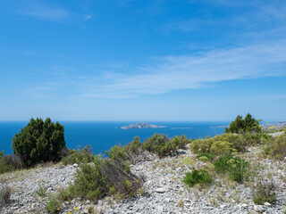Fototapeta premium Calanques, France - May 20th 2020: Hiking high above the Mediterranean Sea along a rocky coast