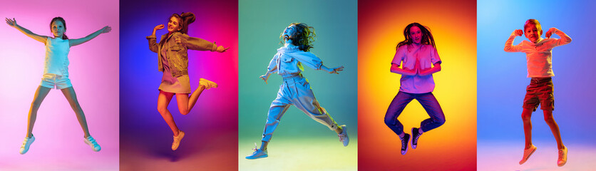 Fototapeta na wymiar Group of elementary school and little kids or pupils jumping isolated in colorful on background in neon light. Creative collage. Back to school, education, childhood concept.