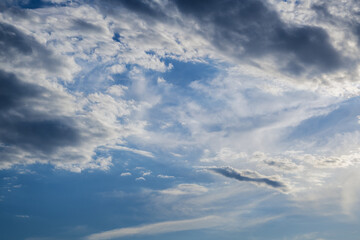 Naklejka na ściany i meble Dramatic blue sky with white clouds.