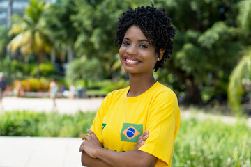 Laughing brazilian female football fan with yellow jersey