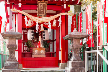 a small red prayer altar of a Shinto shrine in a residential area of the city of Beppu in Japan