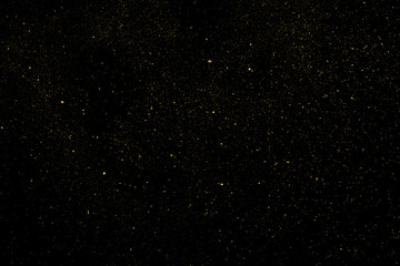 Gold Glitter Texture Isolated on Black Background. Golden stardust. Amber Particles Color. Sparkles Rain. Vector Illustration, Eps 10.