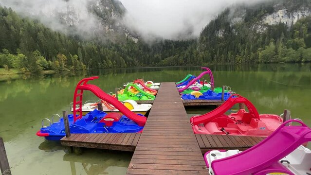 colourful pedal boats at alpine lake