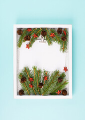 Christmas holiday background, frame with fir branches, stars, candy cane and pine cones, winter season greeting card
