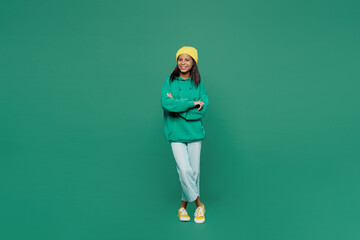 Full body happy little kid teen girl of African American ethnicity 13-14 year old wear casual hoody...