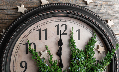 The clock shows midnight. New Year's decorations.