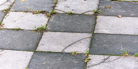 closeup of rough dark and light grey urban surface like a concrete chessboard