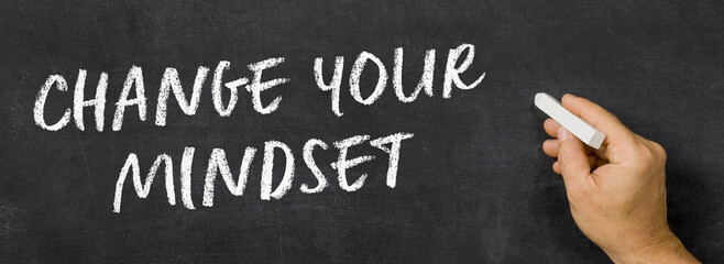  Text written on a blackboard -  Change your mindset