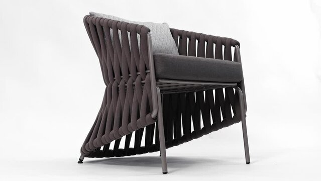 Beautiful modern chair with an unusual weave on a white background. Insulated 