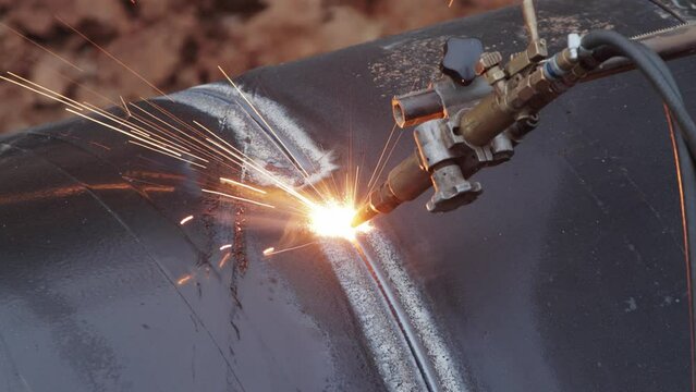 Special pipe cutter for cutting a large gas pipe in the construction of a main gas pipeline. Close-up, industry
