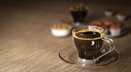 Black coffee in glass cup on brown table with copy space.