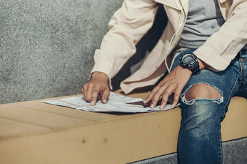 Tourists point their fingers at the map to find attractions, restaurants or hotels..backpacker and travel concept.