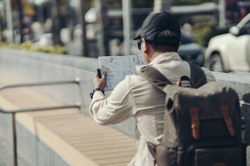 Tourists hold maps to find attractions, restaurants or hotels. backpacker and travel concept.