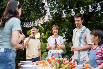 Multi-ethnic big family having fun, enjoy party outdoors in the garden