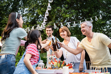 Multi-ethnic big family having fun, enjoy party outdoors in the garden