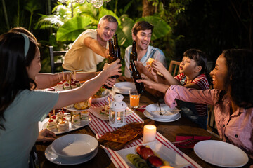 Multi-ethnic big family having fun, enjoy party outdoors in the garden