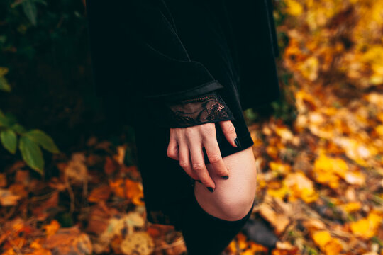 Woman In Black Dress Standing In The Forest, Leaning With Hand On Her Knee, Bare Skin, Detail, No Face