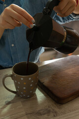 Fototapeta na wymiar girl pouring coffee into a cup