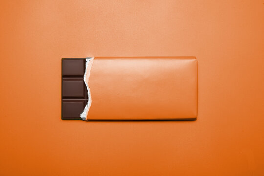 Tafel Schokolade auf orangefarbenem Hintergrund