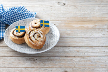 Cinnamon rolls buns on wooden table with copy space. Kanelbulle Swedish dessert