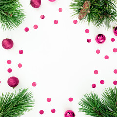 Fototapeta na wymiar Christmas frame of pine branches and decoration balls with confetti on white. Flat lay, top view
