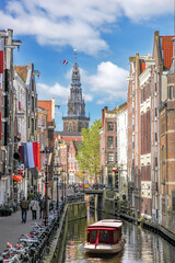 Traditional old buildings and houseboat on canal in Amsterdam, Netherlands