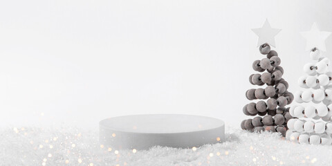 Cosmetic background for Christmas and winter holiday. White podium, christmas trees and snow on...