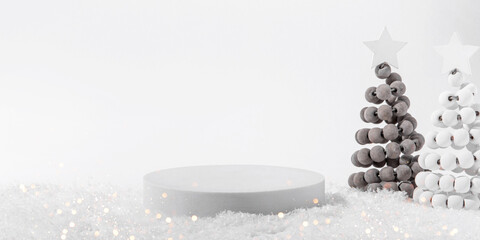 Cosmetic background for Christmas and winter holiday. White podium, christmas trees and snow on white background.