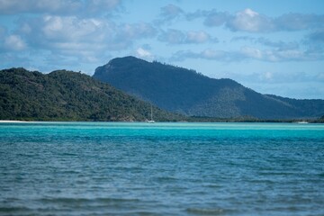 tourists and boats, on the beach at the great barrier reef in the Whitsundays in queensland Australia  
