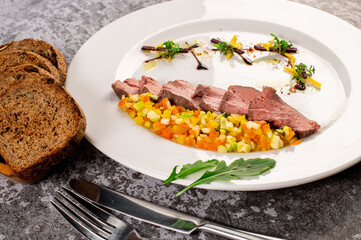 Dish of duck meat with vegetables and herbs. Healthy food
