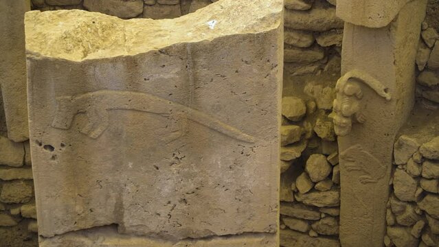 Ancient Archeology Art, Carved Stone Pillar at Göbekli Tepe Neolithic archaeological site in Anatolia Turkey, Old Prehistoric Preserved Iconography on Rock Ruins