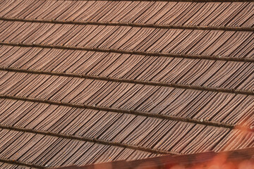 Shingle roof. Detail view with a traditional wooden roof on a traditional house in the mountain area.