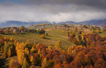Autumn landscape in Romania. Beautiful sightseeing with the fall landscape from villages of Rucar...