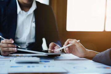 business group people are meeting and discussing budget and marketing plans in order to strategize...