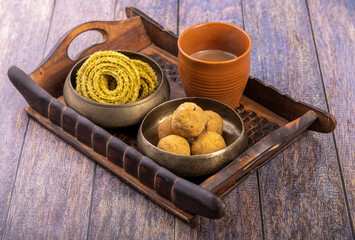 Traditional Indian snack chakli and chana laddu is a welcome snack at the festival, served with tea