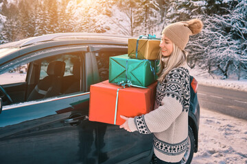 Woman Giving Gifts. Female is holding presents and delivering them on her car to Home. Holidays...