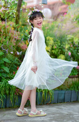 Beautiful asian woman is dancing and spinning with smile in nature park