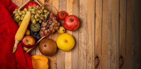 Naklejka na ściany i meble Farm fresh fruits basket with wooden table top view - health and diet concept