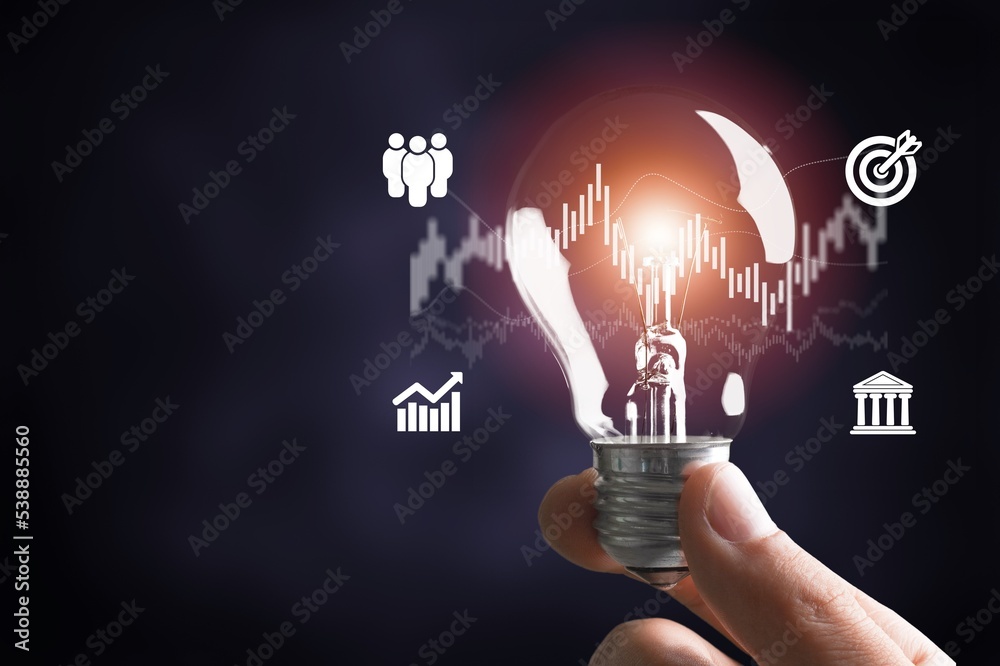 Wall mural businessman hand holding light bulb for ideas concept