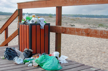 Rubbish overflow outside trash containers and poor waste management in the national park
